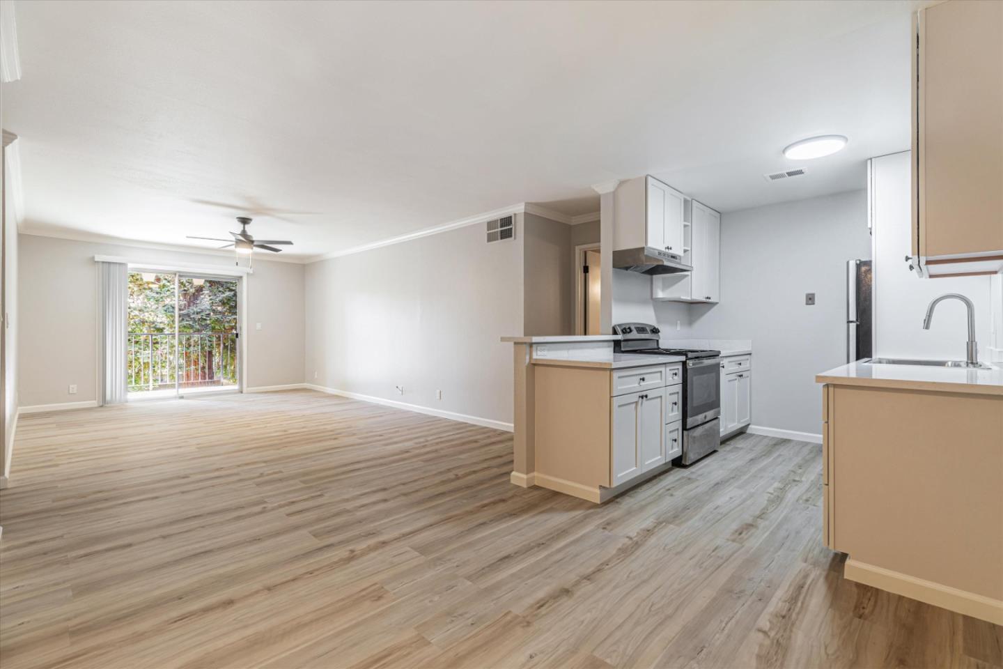 a kitchen with granite countertop a stove top oven sink and cabinets