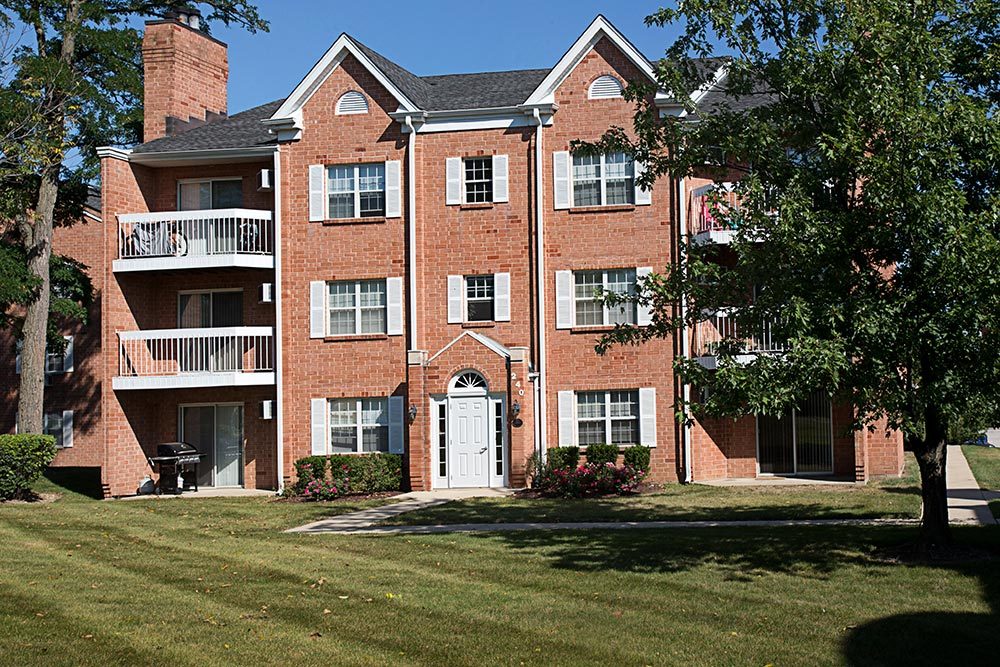 a front view of a residential apartment building with a yard