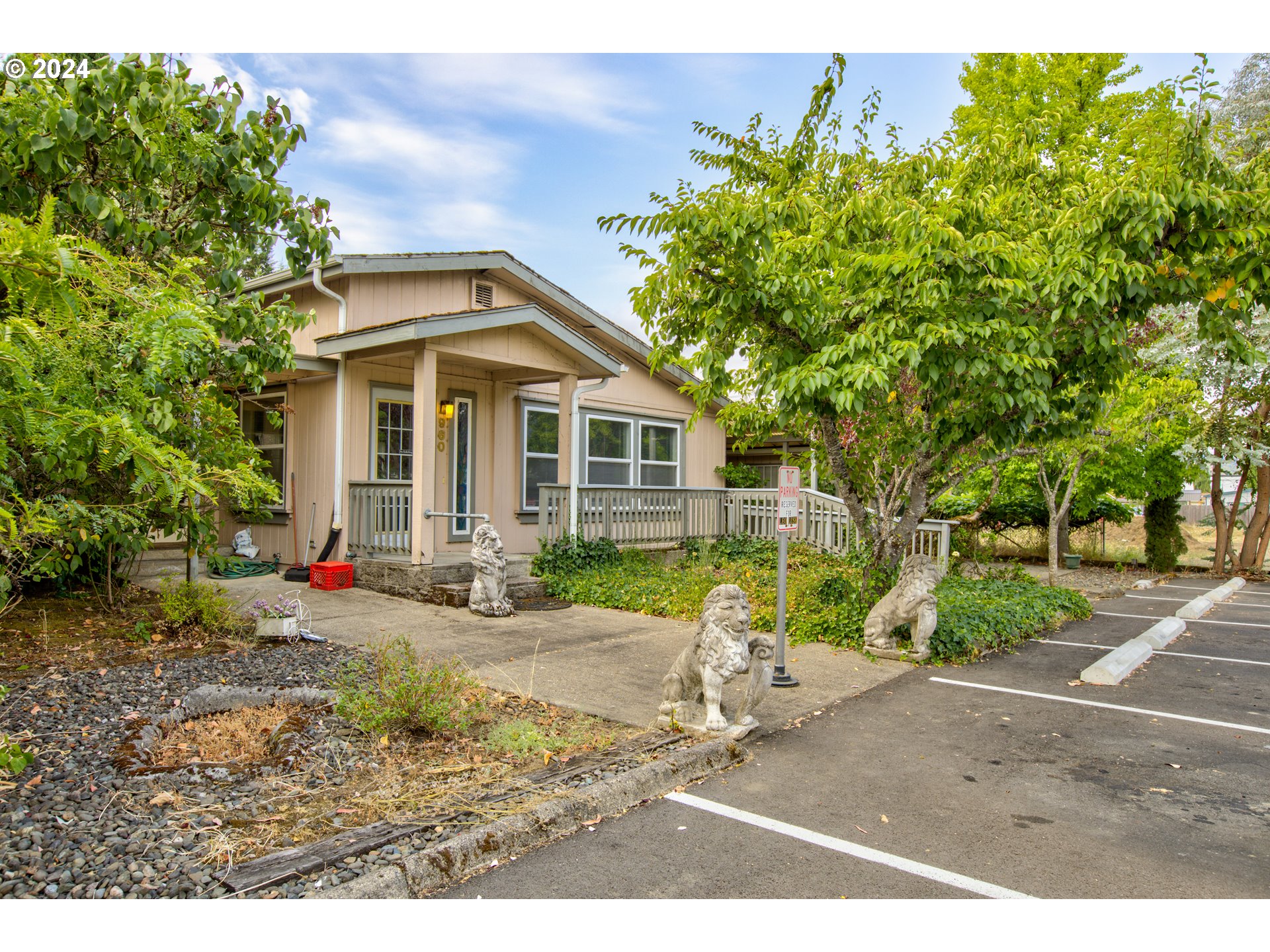 a front view of a house with a yard and trees