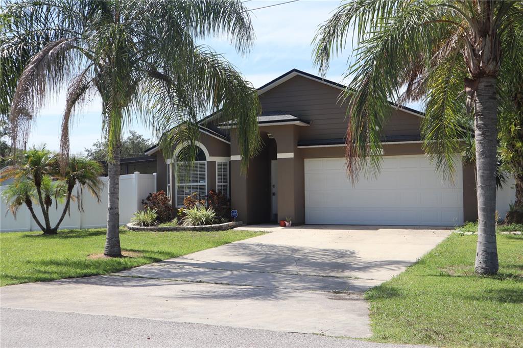 a front view of house with yard and green space