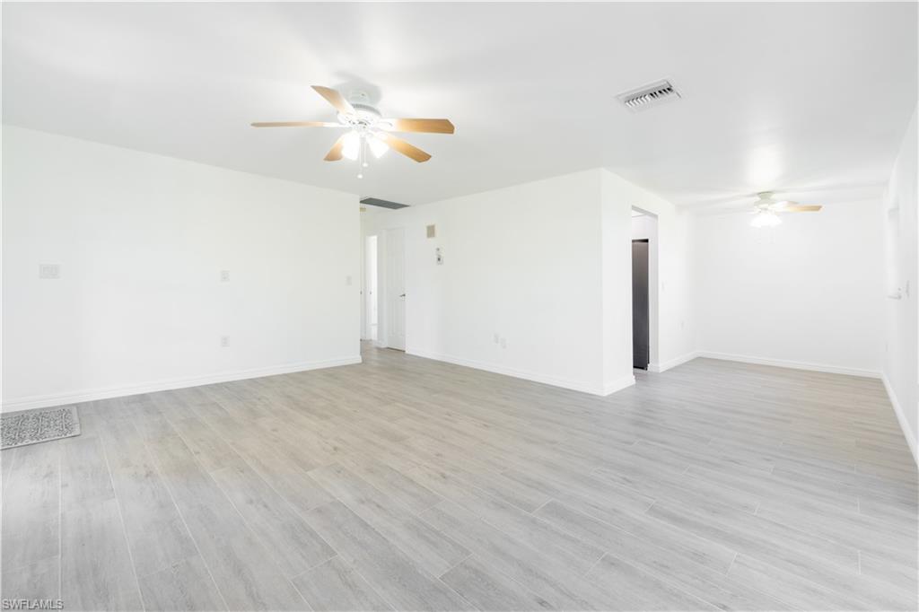 a view of a room with wooden floor