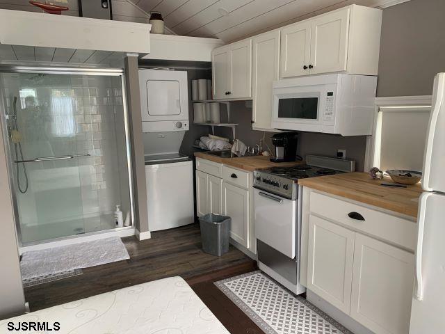 a kitchen with a refrigerator stove and white cabinets