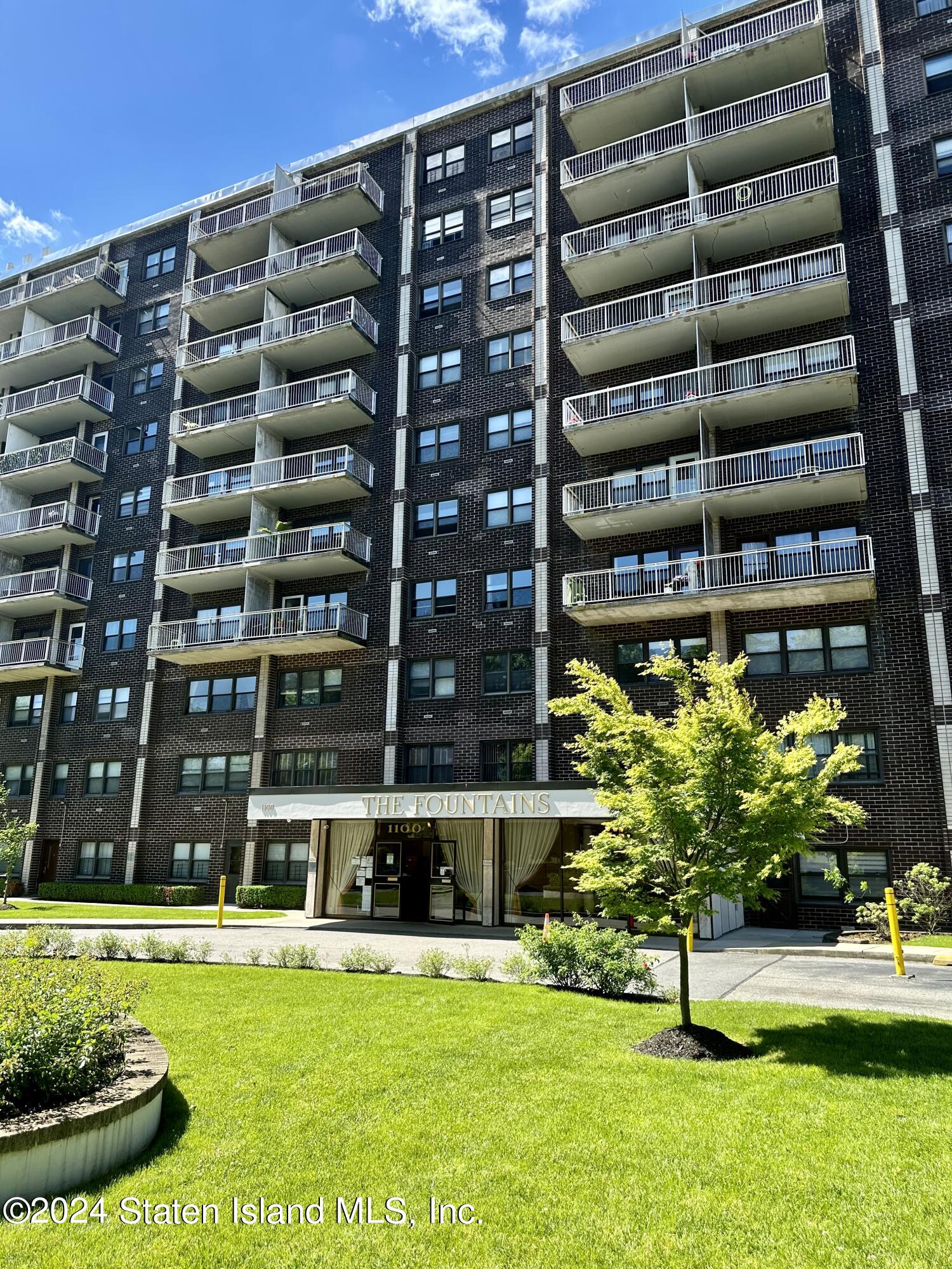 a front view of building with yard