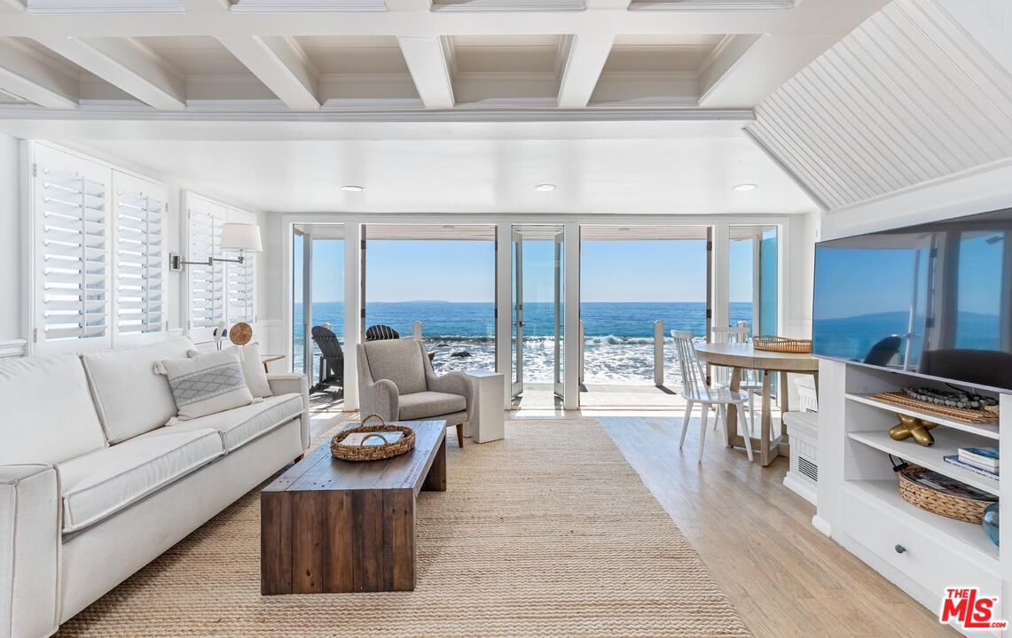 a living room with furniture fireplace and a table