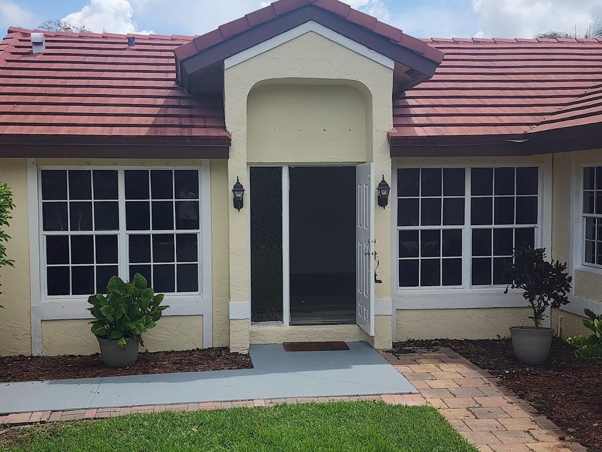 a front view of a house with a garden