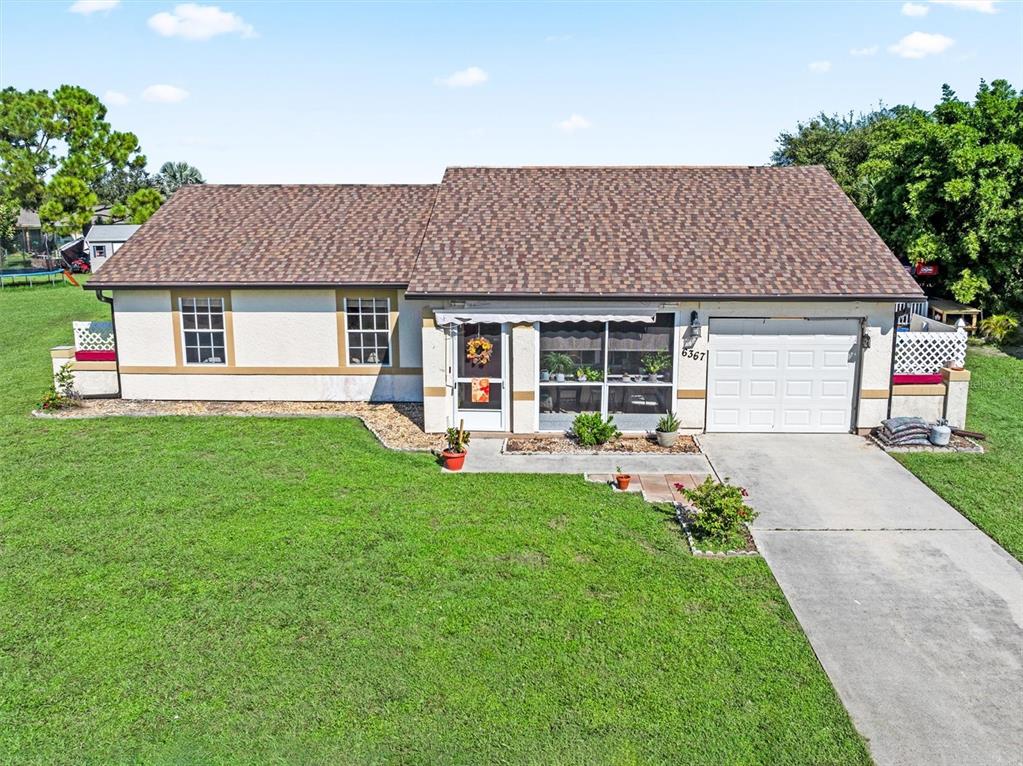 a front view of house with yard and green space