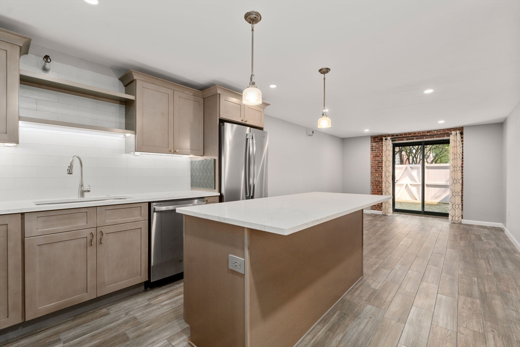 a kitchen with sink cabinets and wooden floor