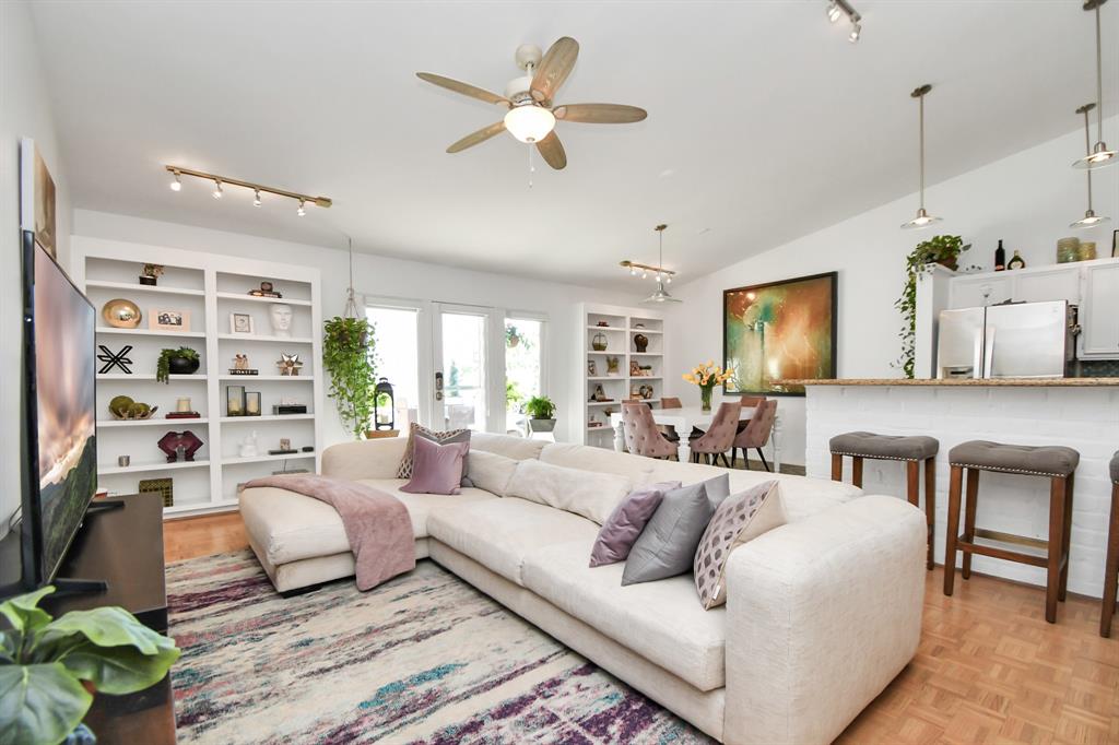 a living room with furniture ceiling fan and a rug