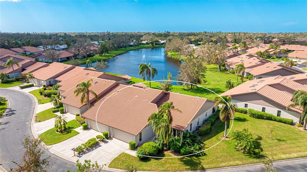 an aerial view of residential houses with outdoor space and ocean view