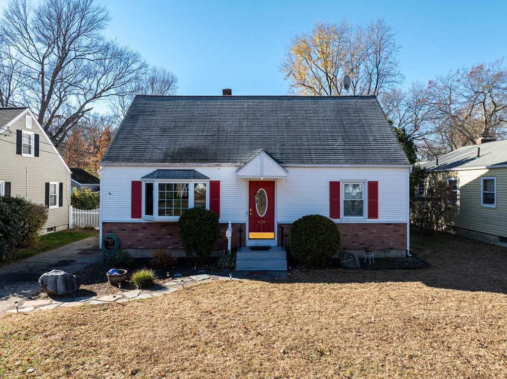 a front view of a house with a yard covered in snow