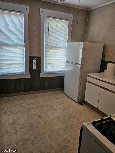 a room with a refrigerator and window