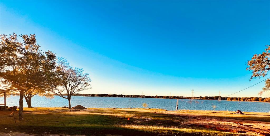 a view of a lake with a house in background