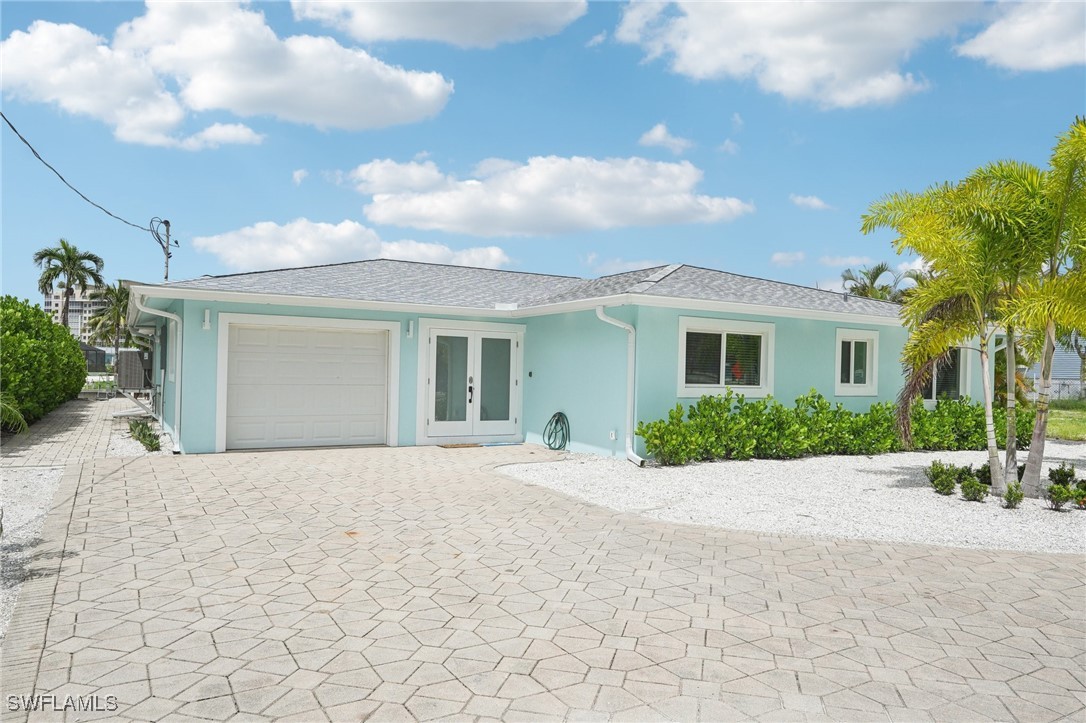 a front view of a house with a yard and a garage