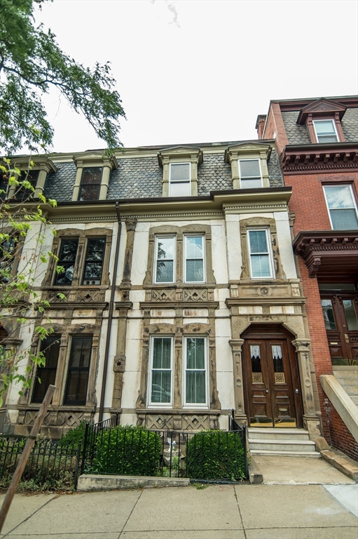 a front view of a residential apartment building with a yard