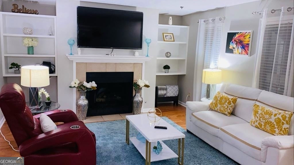 a living room with furniture fireplace and flat screen tv