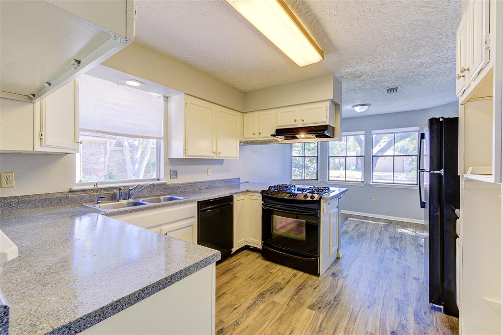 a kitchen with a stove a sink and a refrigerator