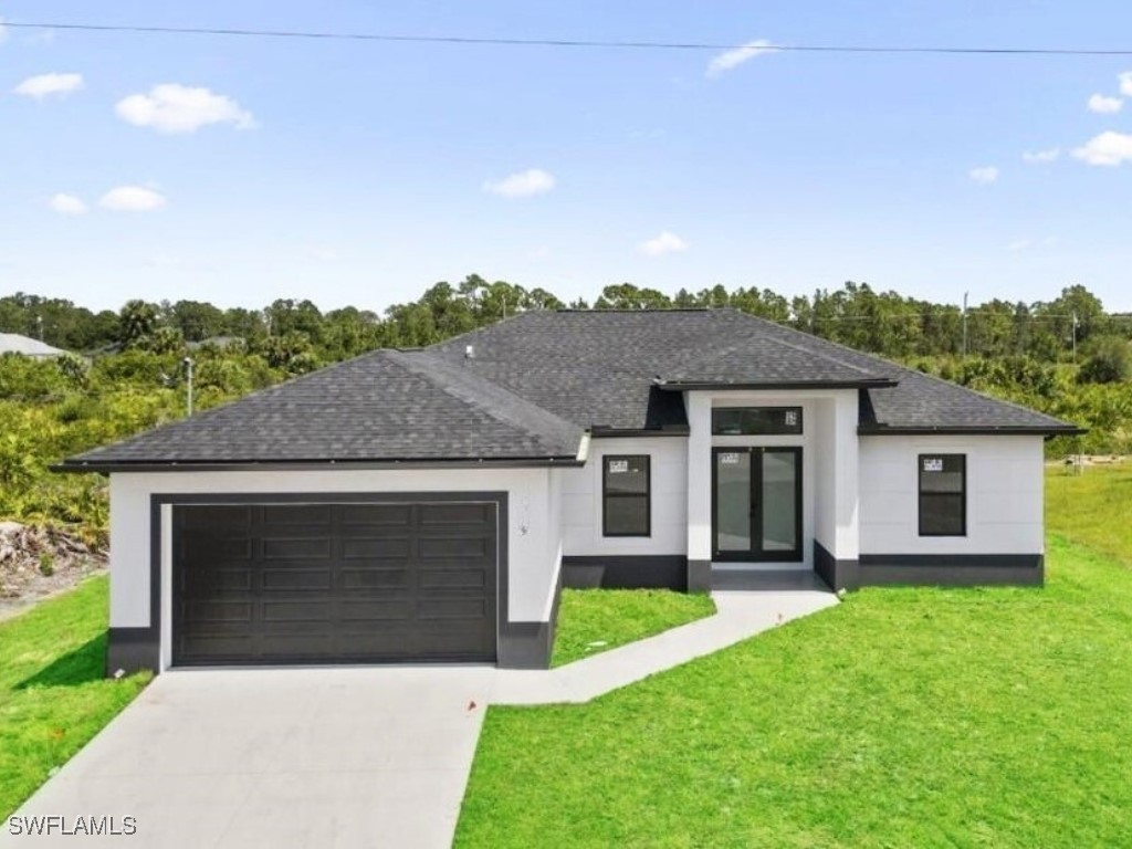 a front view of a house with a garden and yard