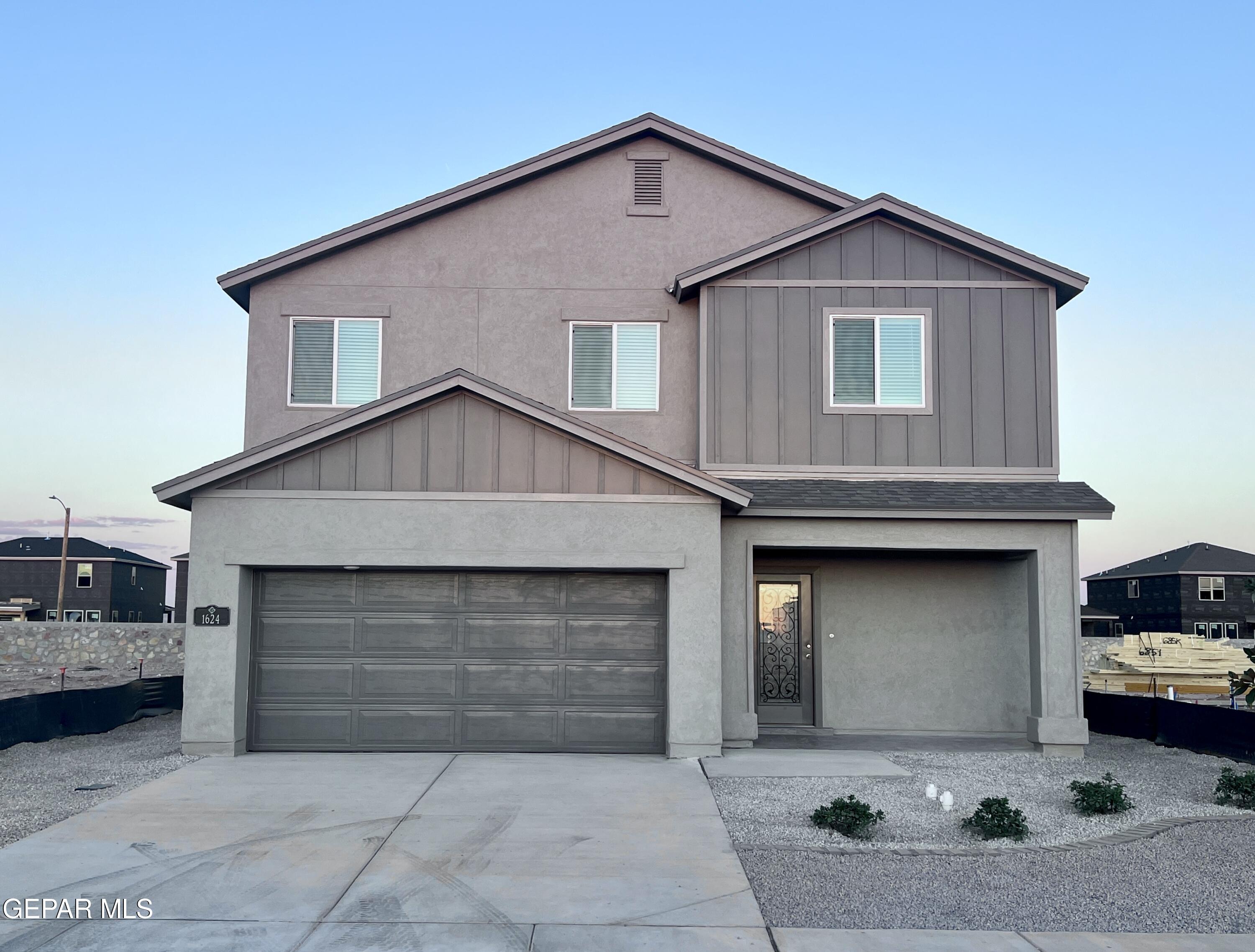 a front view of a house with garage