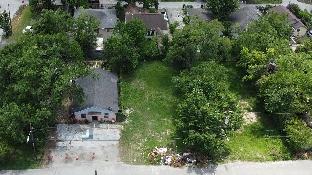 an aerial view of a house with a yard and lake view