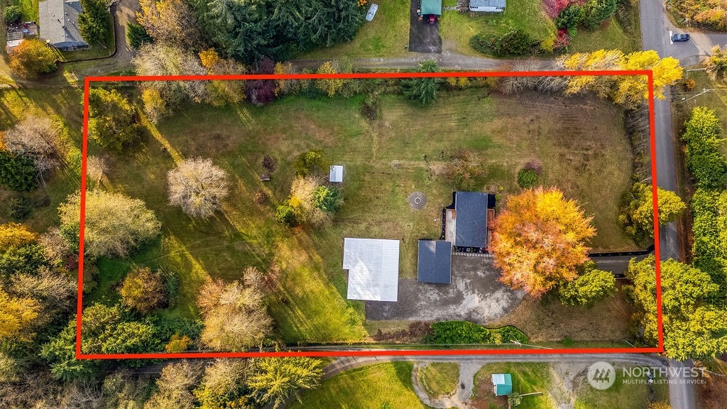 an aerial view of a houses with yard