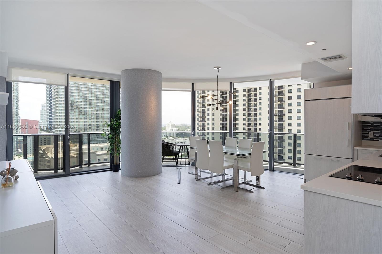 a view of a livingroom with furniture water view and wooden floor