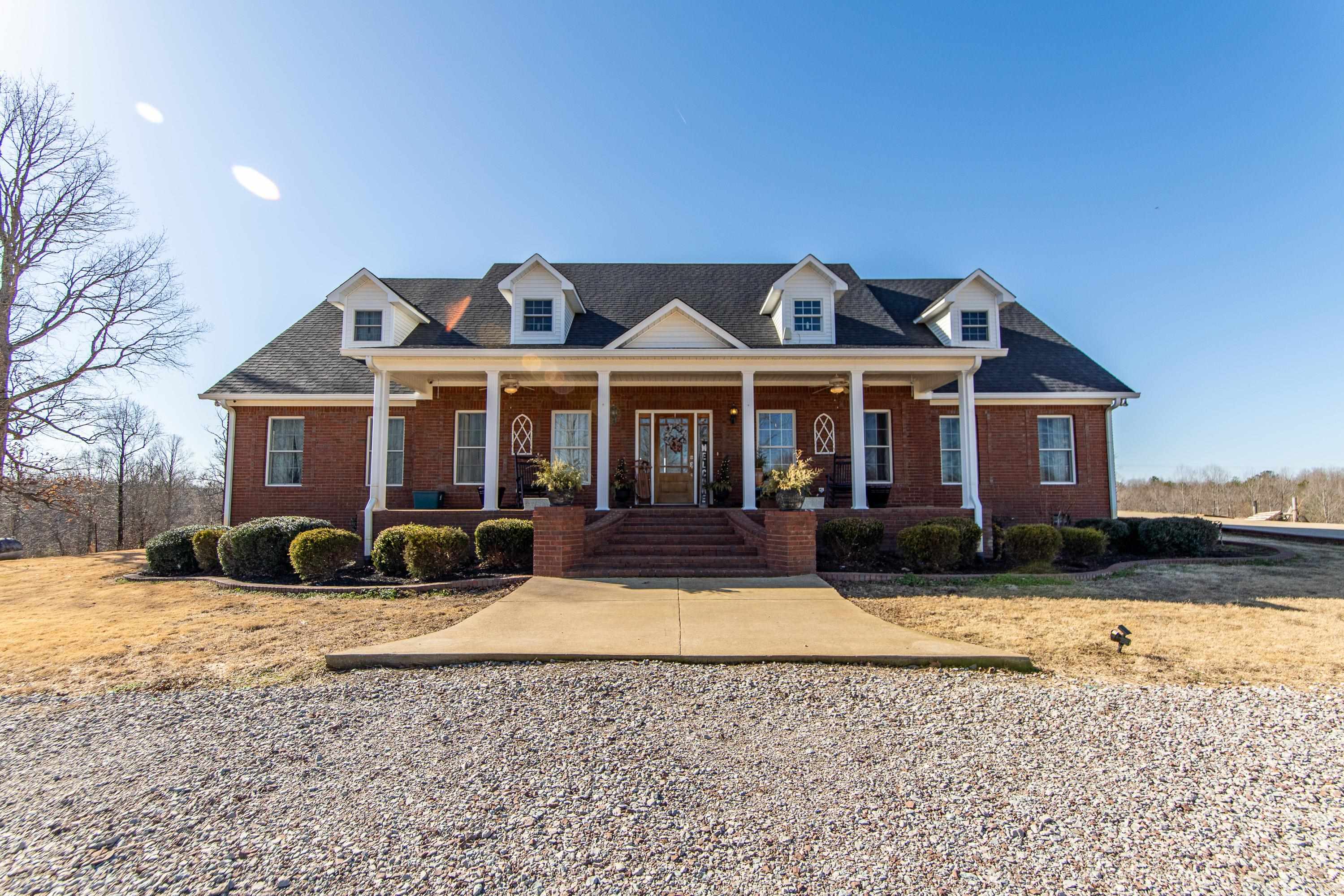 a front view of a house with yard patio and fire pit