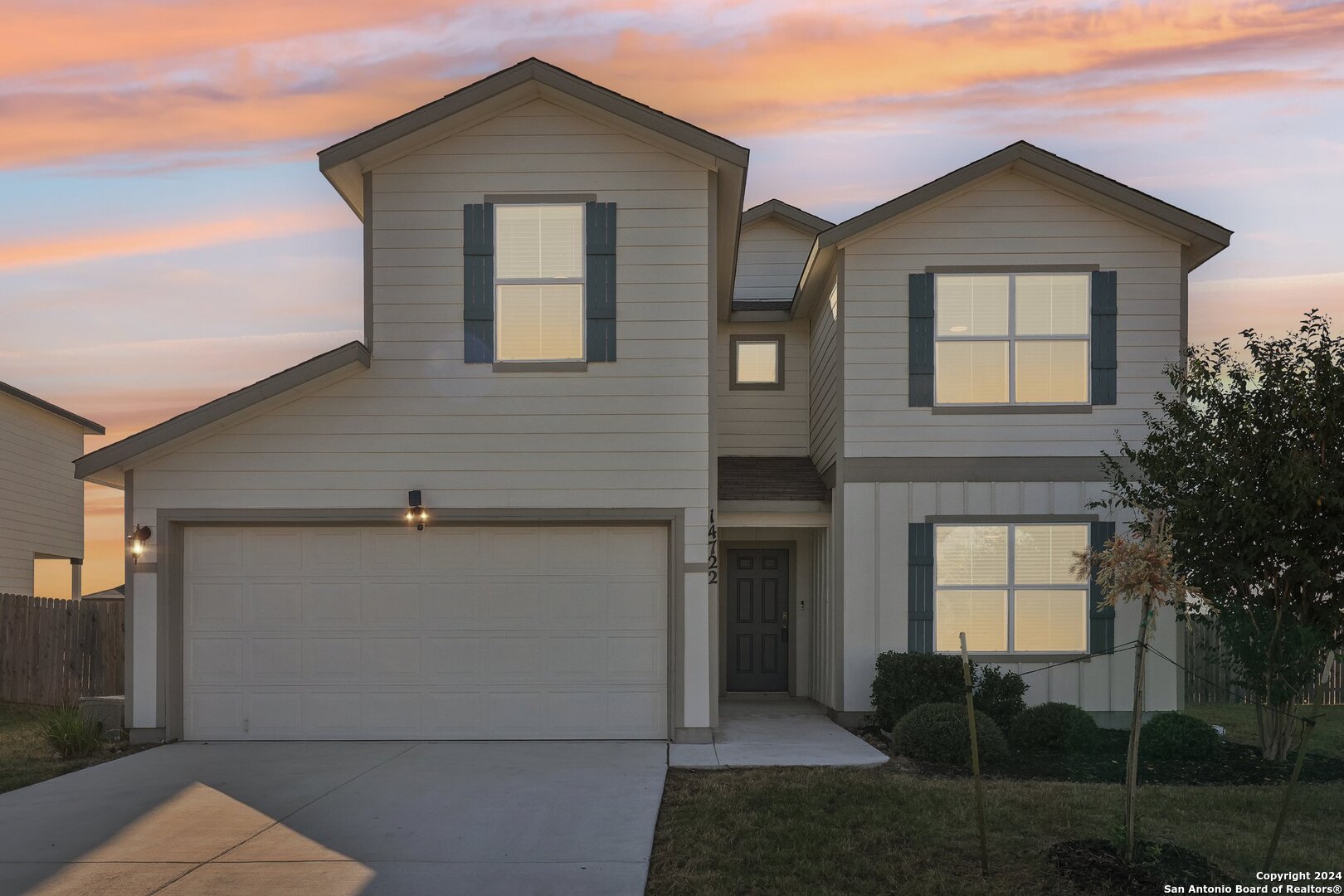 a front view of a house with a yard and garage