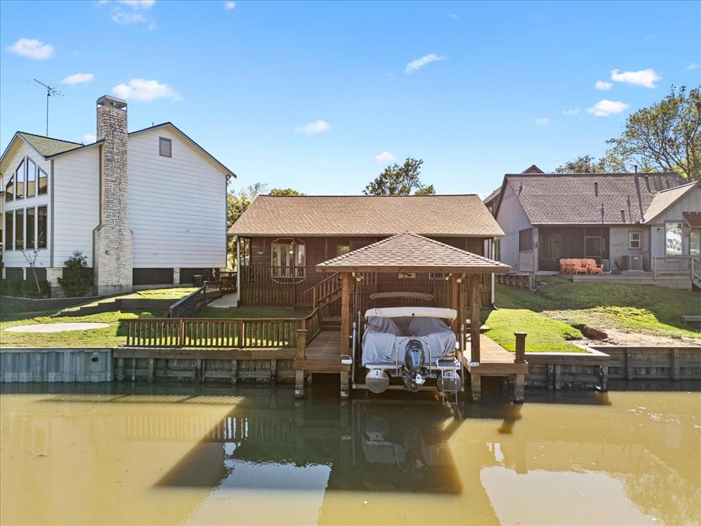 a view of swimming pool with outdoor seating and house in the background