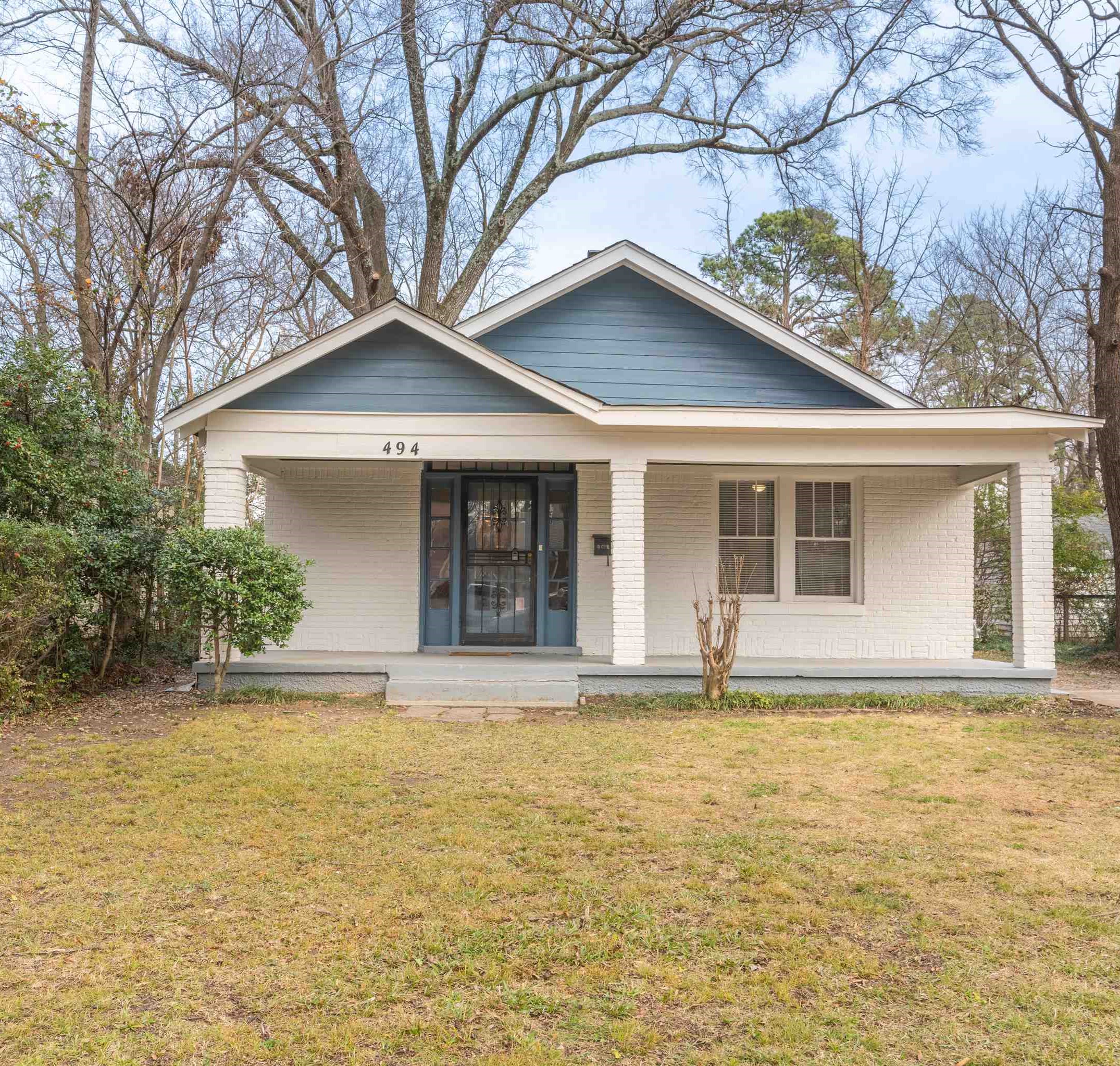 Bungalow-style house with cooling unit, covered porch, and a front yard