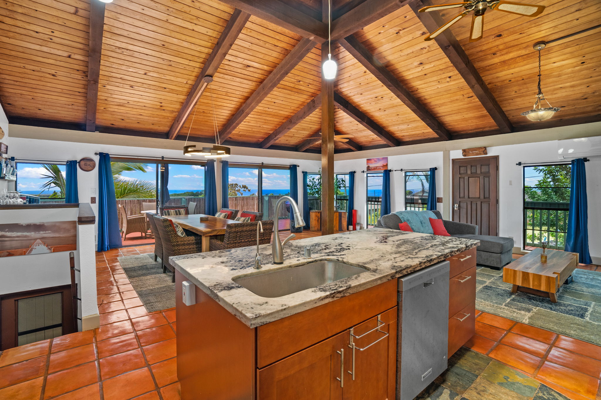 a kitchen with a sink and large windows