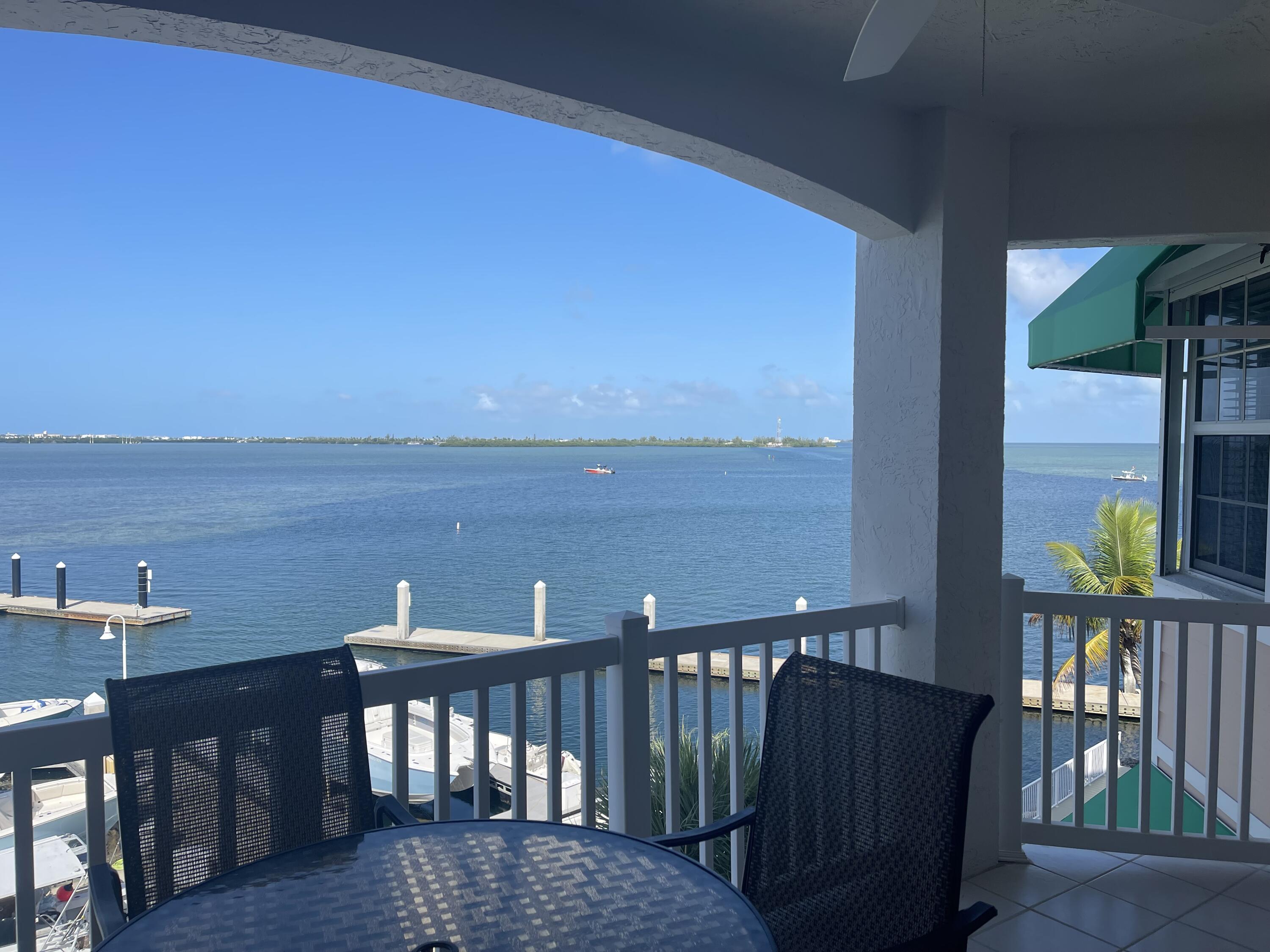 a view of roof deck with two chairs and wooden fence