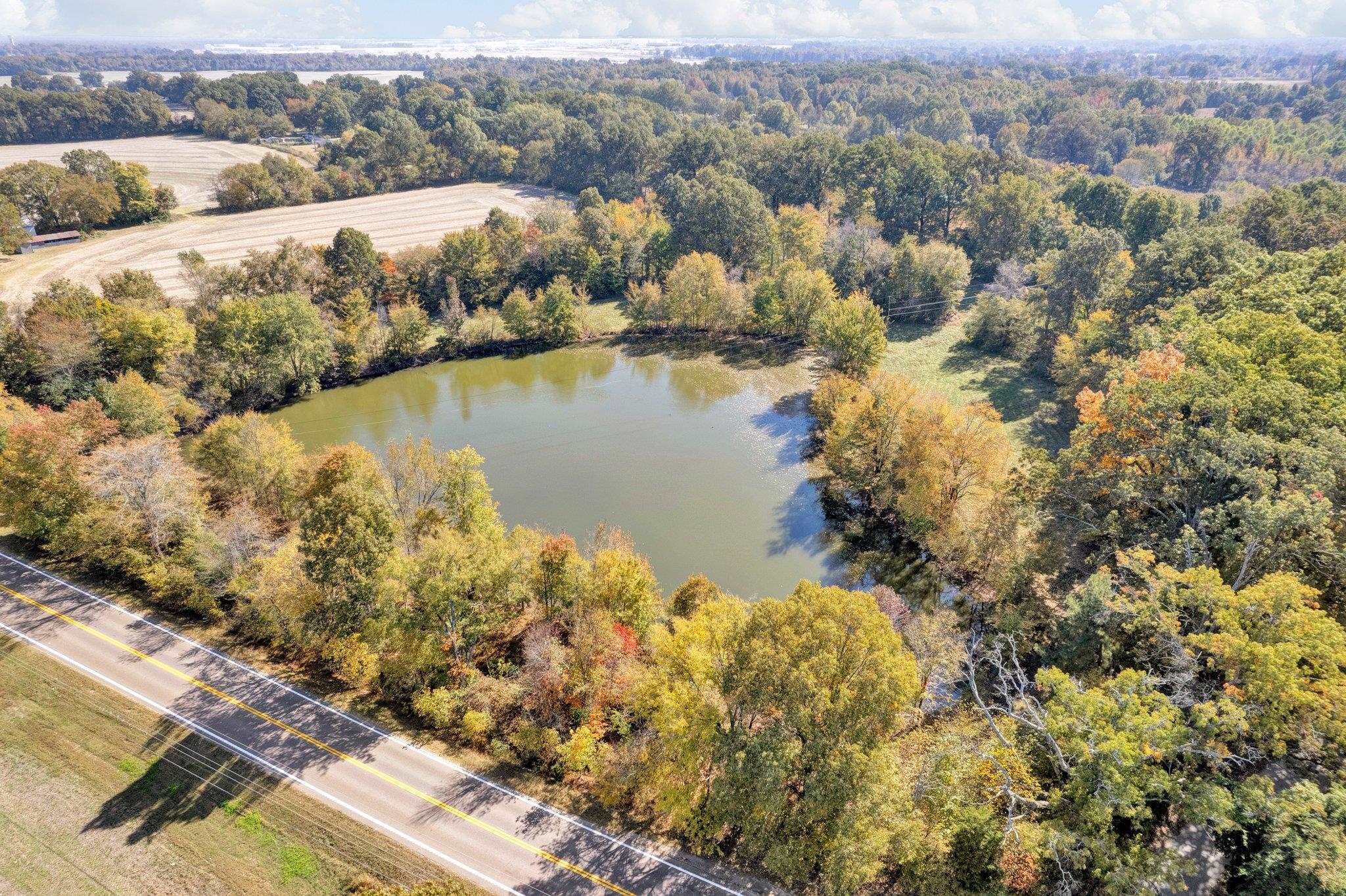 an aerial view of a house with a lake view