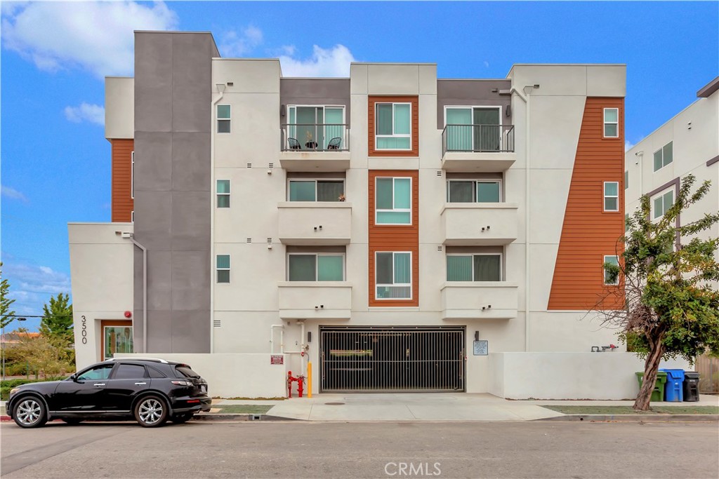 a couple of cars parked in front of a building