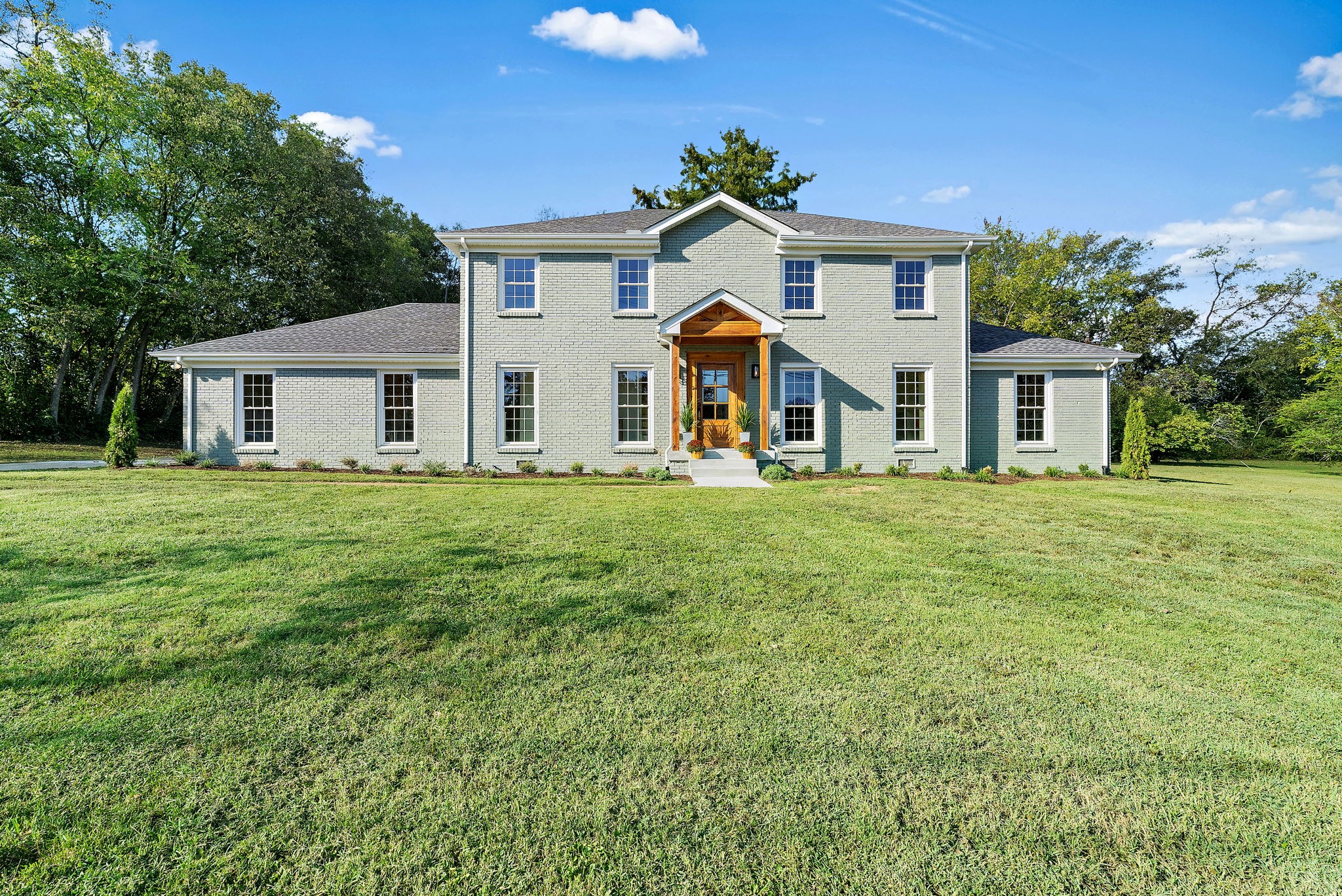 a front view of a house with a yard