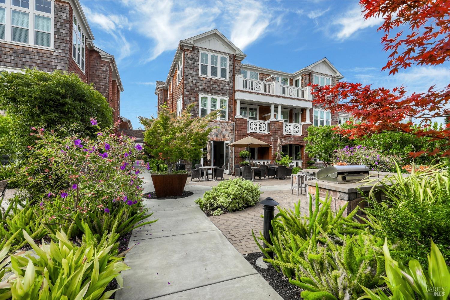 a front view of a house with a yard and fountain