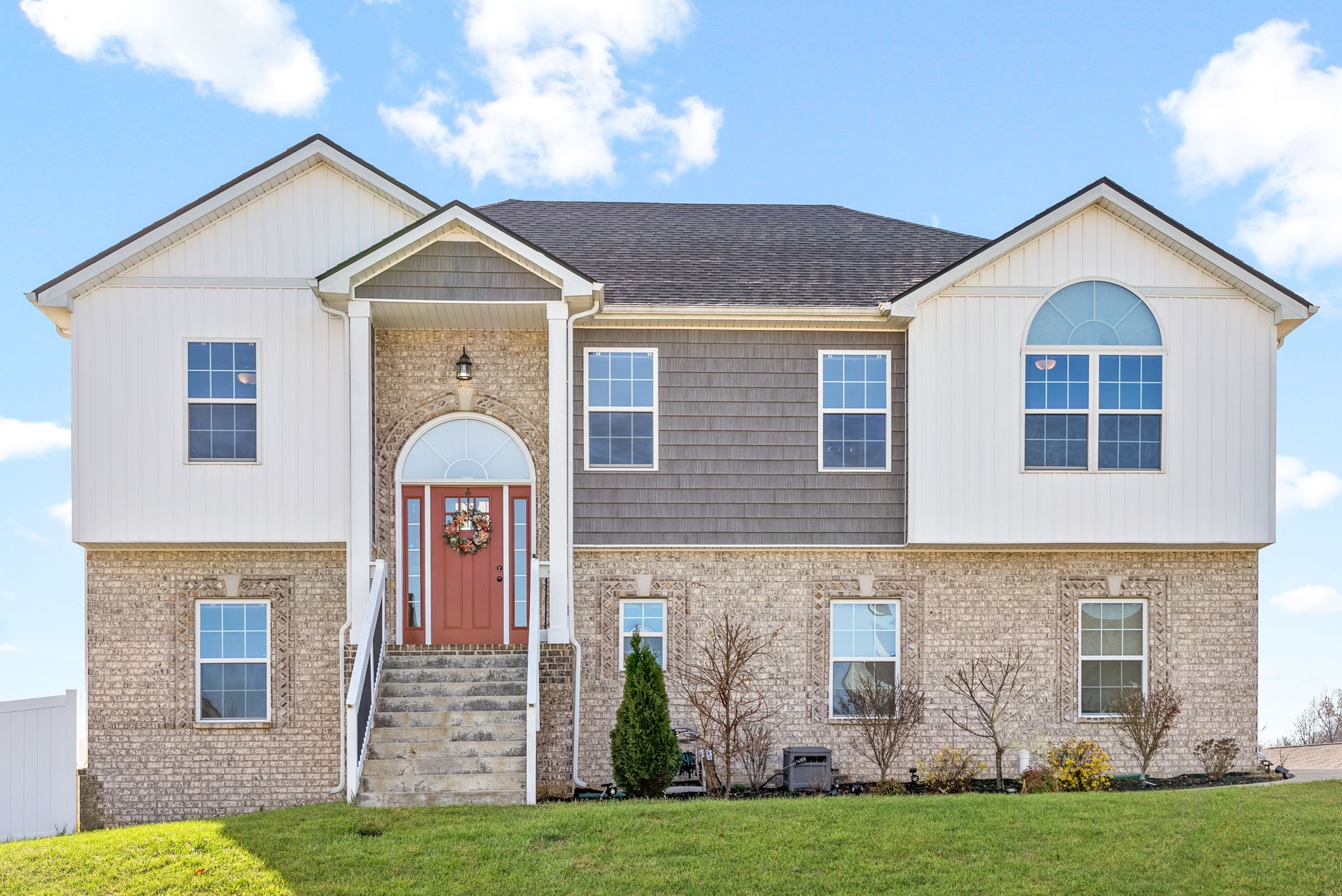 a front view of a house with a yard