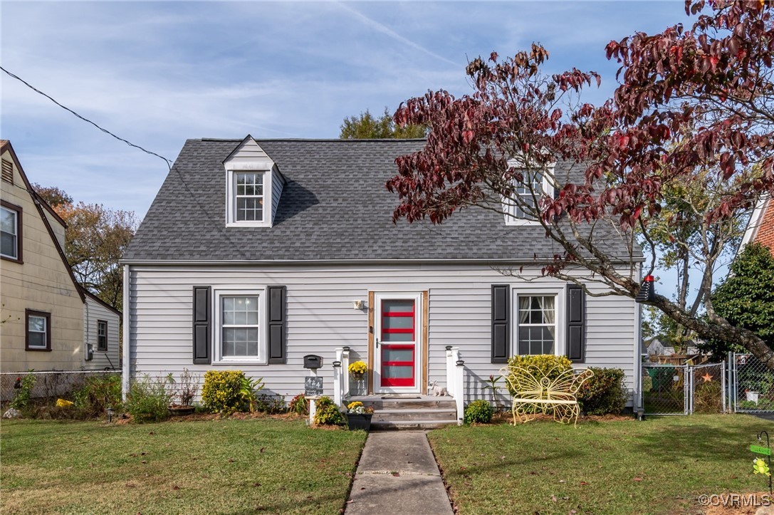 a front view of a house with a yard and potted plants