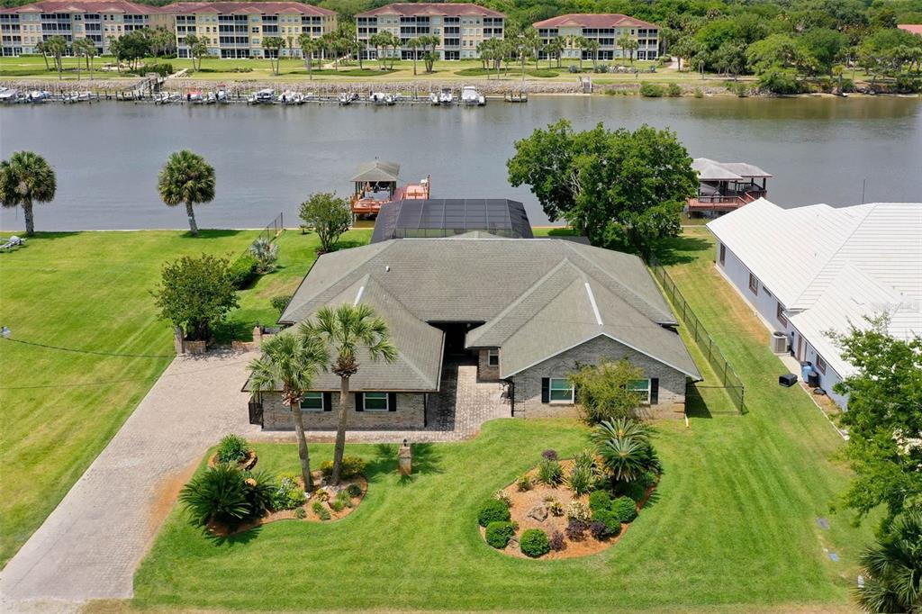 an aerial view of a house with a lake view