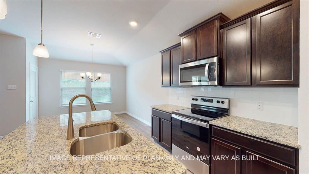 a kitchen with granite countertop stainless steel appliances and wooden cabinets