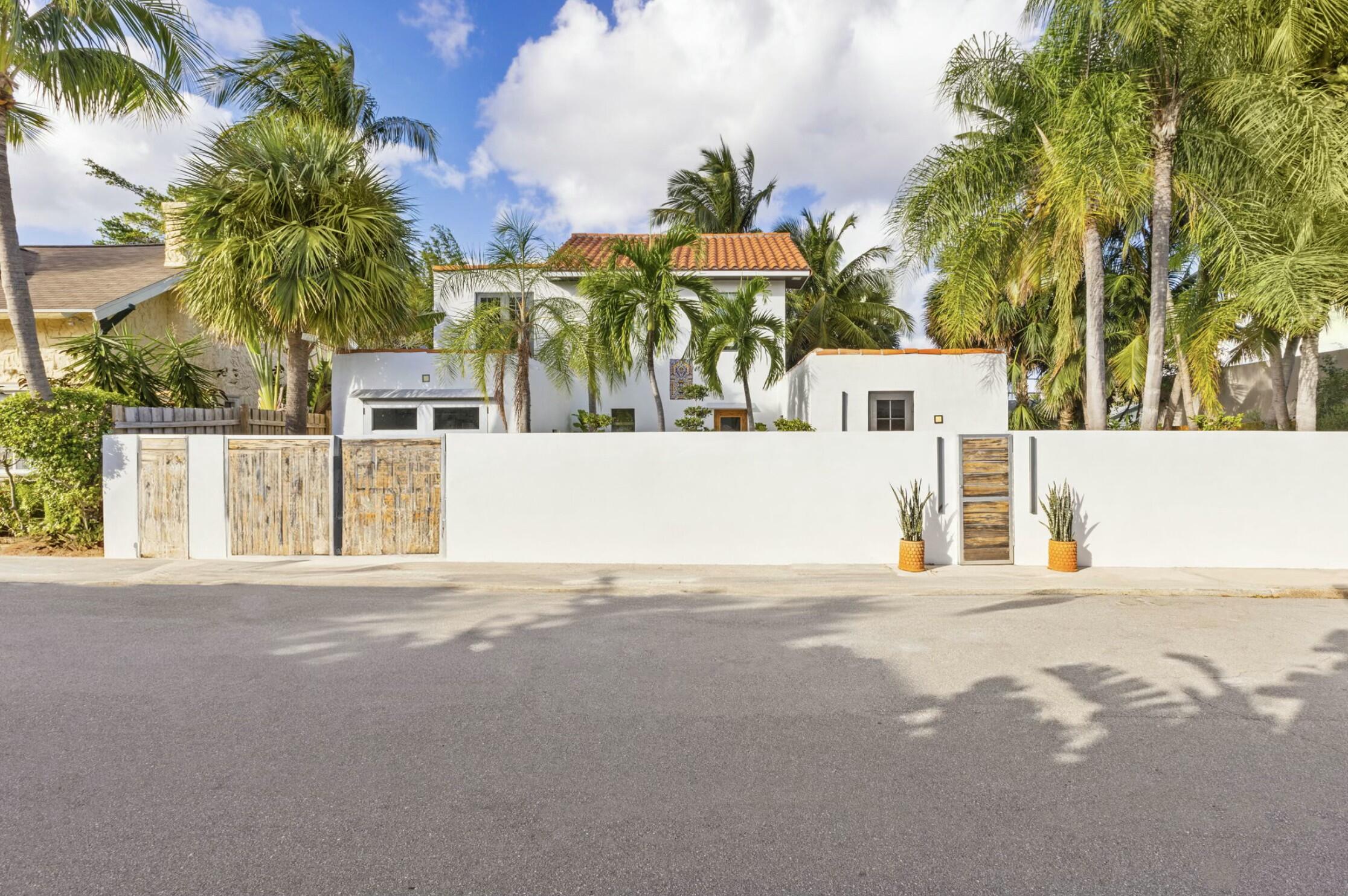 a view of a white house with a yard and a garage