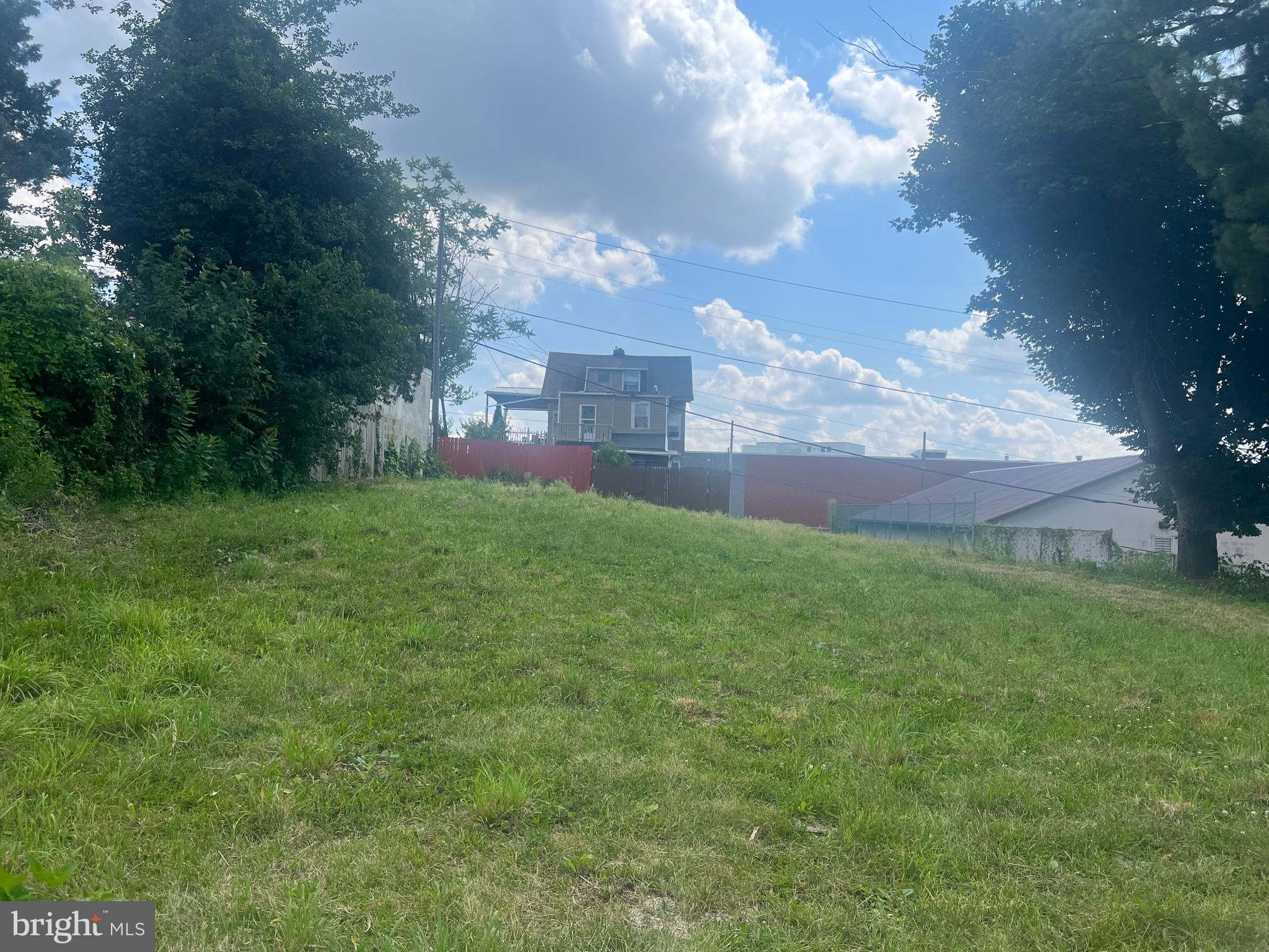 a view of a big yard with a house in the background