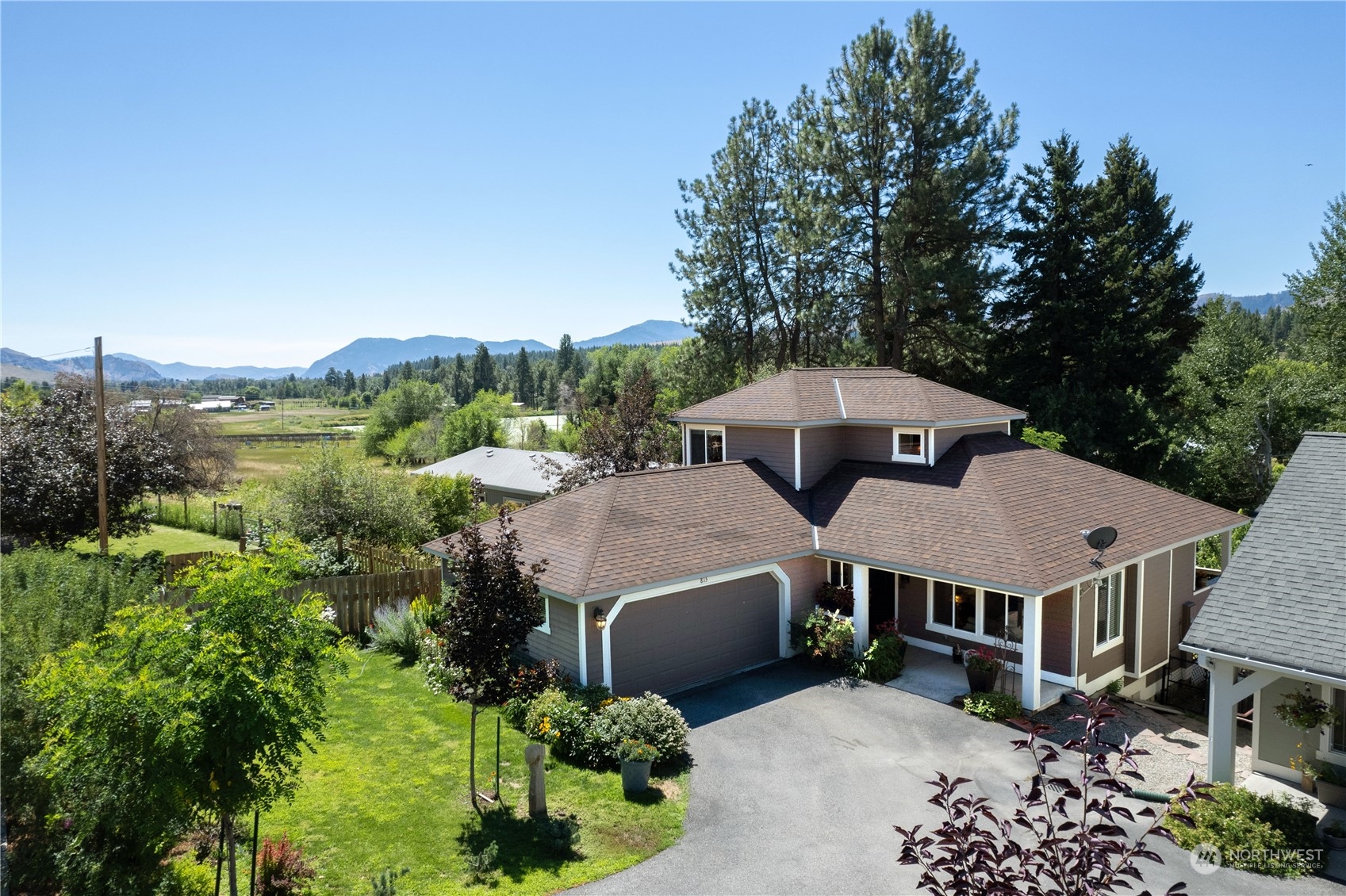 an aerial view of a house next to a yard