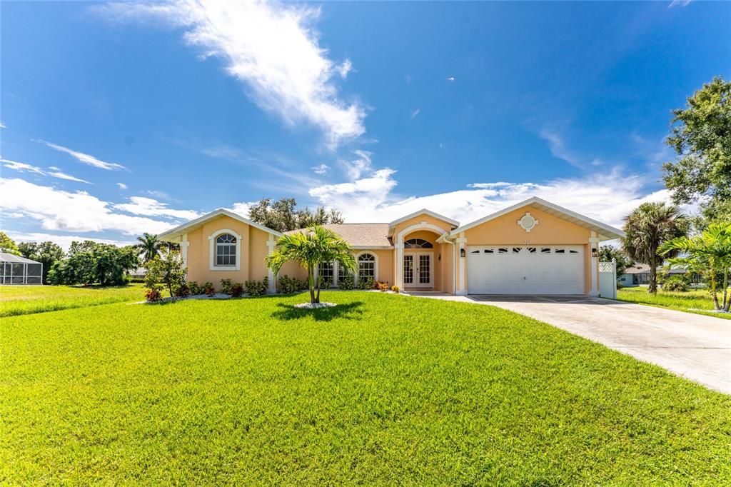 a front view of a house with a yard and garage