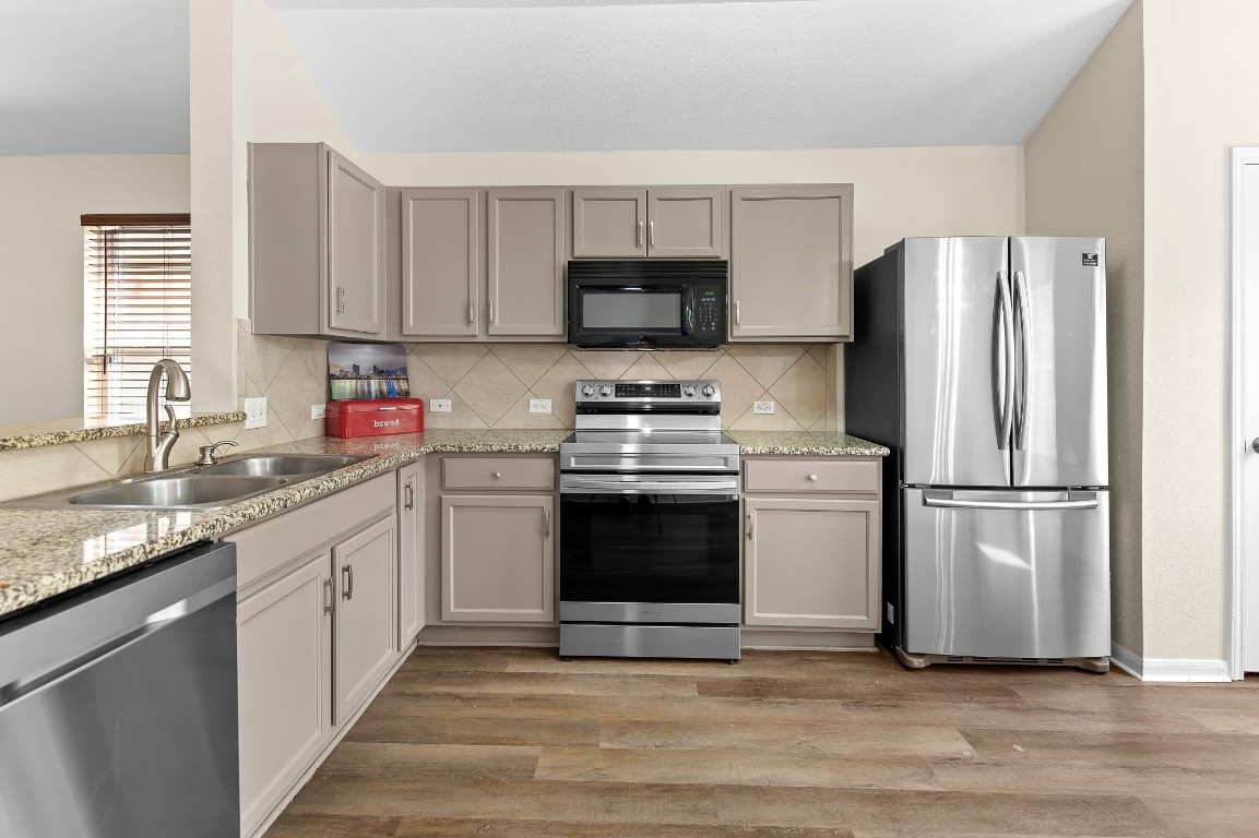 a kitchen with a sink a stove and refrigerator