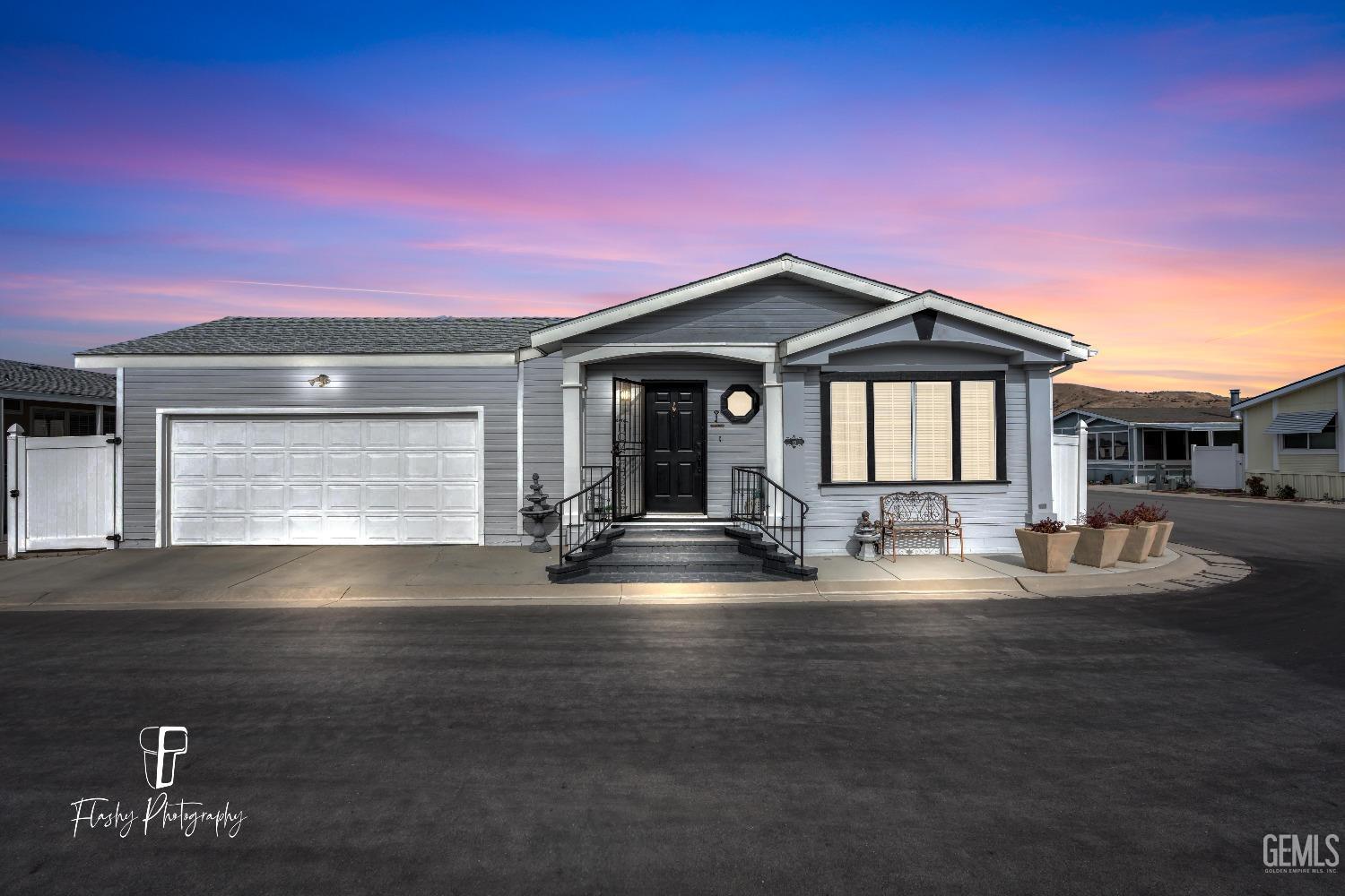 a front view of a house with yard and garage