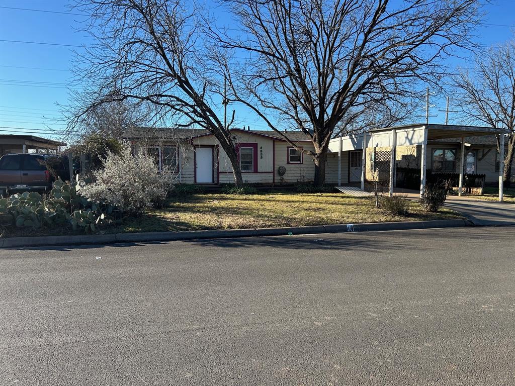 a view of a house with a large tree