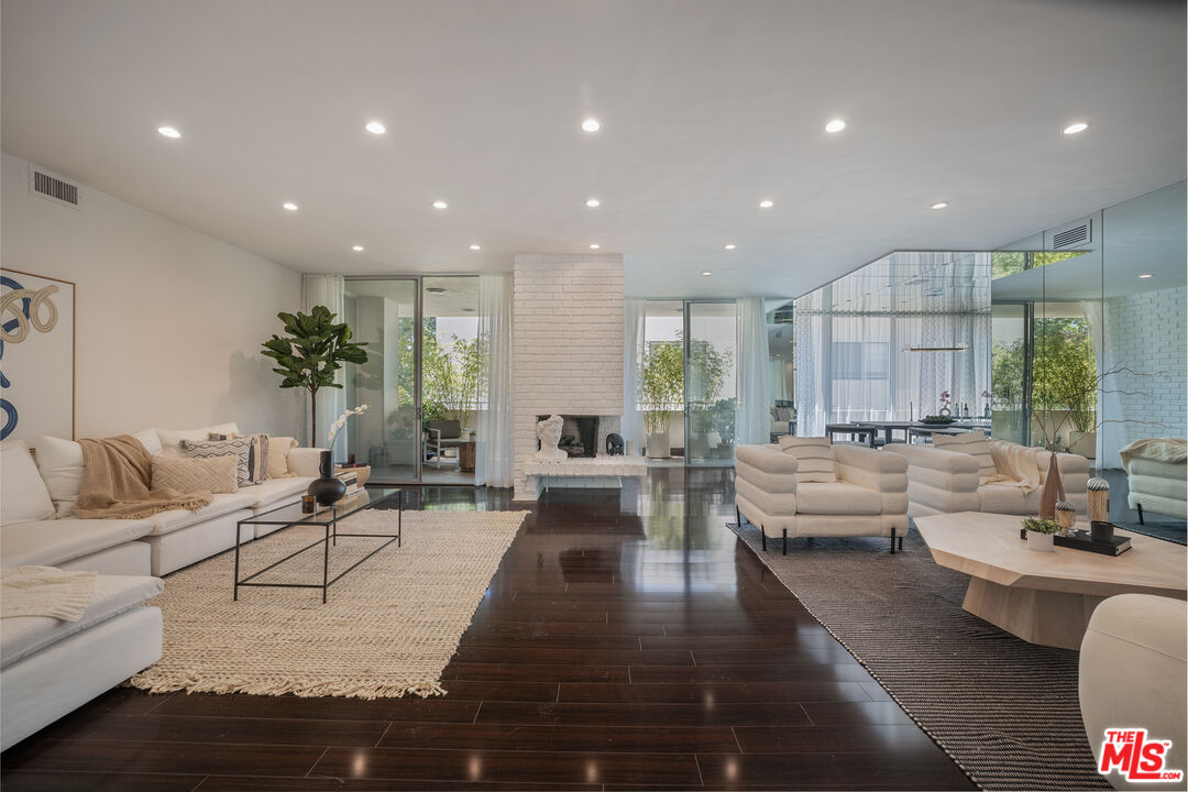 a living room with furniture or couch and a large window