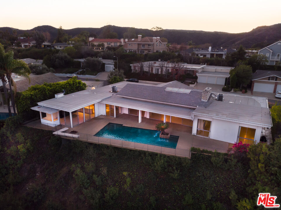 an aerial view of residential houses with a city view