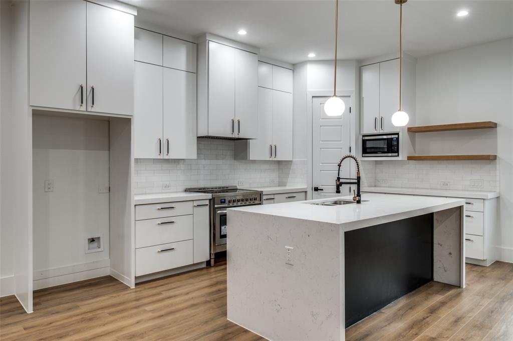 a kitchen with a sink stove and cabinets