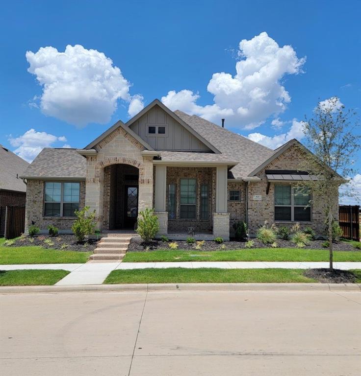 a front view of a house with a porch and a yard